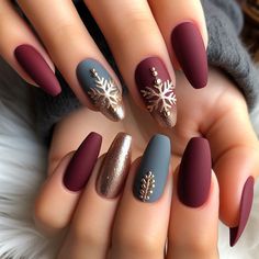 Elegant winter nail art with a matte finish in deep burgundy, adorned with gold snowflake accents Teal And Burgundy Nails, Winter Floral Nails, Winter Nails Design, Pastel Nail Art, Teal Nails, Winter Manicure, Festive Nail Art, Nail Color Trends, Gold Snowflake