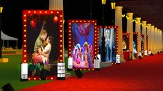 a red carpeted walkway lined with lighted billboards