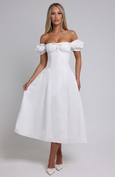 The dreamy Elora dress is ultra feminine, made in our premium non-stretch cotton blend fabric that feels as good as it looks. With a super cinched waist, the puff sleeves and bust are gathered with a tie detail for a super pretty finish. The midi skirt is complete with a dropped waist silhouette. Style it up with an effortless knot and heeled mules. 



Colour: Ivory.

Premium non-stretch cotton blend fabric.

Elasticated puff sleeves which can be worn on or off the shoulder.

Ruched, gathered c Homecoming Dresses Corset, White Dress Spring, Midi Dress Wedding Guest, Dresses Flowy, Split Long Dress, Ultra Feminine, Maxi Dress Sale, Sparkle Dress, Dresses By Length