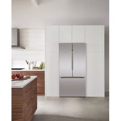 a stainless steel refrigerator in a white kitchen