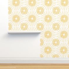 a white wall with yellow sunburst pattern on it