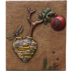 a ceramic tile with a tree and pomegranate on it