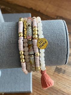 This 4mm pink stack consists of 5 bracelets, perfect for everyday wear and every occasion.  *In this stack you will receive* * 2 Heishi bracelets with gold round beads and an S&L charm.   * Pink aventurine with 14k gold beads and a dark pink tassel.  * Natural stone bead in clear and watermelon with gold spacers.  * Iced coffee jade bead with gold accent.   All S&L Stackz come in a muslin bag for easy storage and gifting! If you need a special gift for that someone, these stacks are perfect!  Bracelets are made with quality stretchy elastic material. Heishi bracelets have double elastic.  >> Try rolling one bracelet at a time << >>Do not over stretch<< > Please keep in mind, this stack is made to order. FINAL SALE > Color & size of beads may vary due to supply.  > Follow instructions of ca Gold Heishi Beads Stackable Bracelets, Gold Stackable Beaded Bracelets With Heishi Beads, Pink Spiritual Stackable Beaded Bracelets, Pink Stackable Heishi Beads Bracelets, Everyday Pink Stackable Beaded Bracelets, Pink Heishi Beads Bracelet With Gold Beads, Gold Stacked Heishi Beads Jewelry, Pink Stacked Beaded Bracelets Gift, Pink Stacked Beaded Bracelets For Gifts