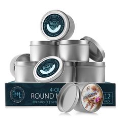 the round tins are stacked on top of each other in front of a box