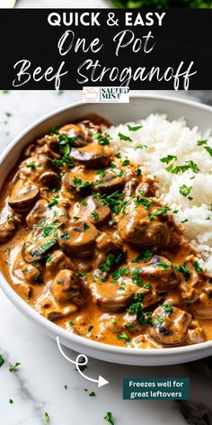 a white bowl filled with beef and mushroom stew next to rice on a marble counter