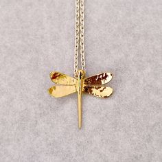 Dragonfly necklace with 18 Kt gold pendant and sterling silver chain. The dragonfly has a width of 2 cm and a height of 1.6 cm, the finish is glossy. Made in Italy. Design by Calcagnini Gioielli. All the jewels I make are shipped inside a beautiful gift box. To see more, please visit my shop at: https://www.etsy.com/it/shop/calcagninigioielli Adjustable Gold Dragonfly Jewelry, Nickel-free Gold Dragonfly Jewelry, Handmade Gold Dragonfly Jewelry, Gold Dragonfly Necklace For Gift, Adjustable Dragonfly Necklace For Gifting, Adjustable Dragonfly Necklace For Gift, Yellow Gold Dragonfly Jewelry Gift, Yellow Gold Dragonfly Jewelry For Gifts, Handmade Dragonfly Necklace For Gift