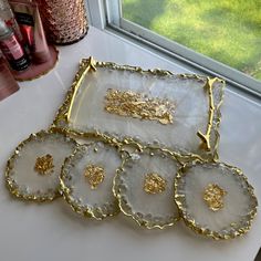 four decorative trays sitting on top of a counter