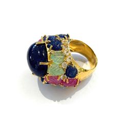 his is part of Chairish’s Fine Jewelry assortment.  Natural Blue Sapphire, Royal Blue Color, From Sri Lanka, Cabochon shape - 12 Carats   Carved floral Emeralds, Sapphires and Rubies - 6 Carats   White topaz - 1 Carat   This Ring is from the "Orient" traveling collection are the epitome of elegance and versatility. It offers a perfect blend of day to night and swimwear to evening wear, allowing you to effortlessly transition between different occasions and outfits. Wearing these spectacular orie Elegant Multicolor Cabochon Rings, Multicolor Cabochon Rings For Formal Occasions, Formal Multicolor Cabochon Rings, Luxury Cabochon Sapphire Ring For Wedding, Luxury Multicolor Cabochon Rings, Luxury Multicolor Oval Gemstones, Luxury Multi-stone Sapphire Gemstones, Luxury Multicolor Sapphire Ring For Formal Occasions, Exquisite Multicolor Ring For Formal Occasions