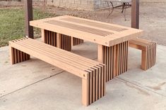 two wooden benches sitting next to each other on a sidewalk