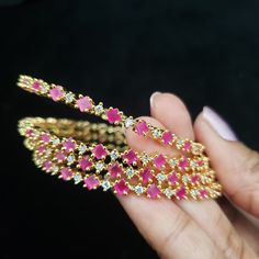 "Pls. Note: Last 2 pics are only showing different colors that are available. The price is only for pink bangles. * Handcrafted Gold Plated bangle Set. * Bangles are made with high-quality Semi-Precious Ruby and American Diamonds stones * High Quality 22 K Gold Plated- Bangle set. * Sold as a set of 4. * Sizes : 2.2 has a 2.2\" inner circle diameter ; 2.4 ( 2.30\" diameter of the inner circle) ; 2.6 ( 2.46\" diameter of the inner circle); 2.8 (2.54\" diameter of the inner circle) 2.10 (2.60\"dia Traditional Pink Bangle As Gift, Traditional Pink Bangle For Gift, Traditional Pink Bangle For Party, Pink Bollywood Bracelets For Festivals, Pink Ruby Stackable Jewelry, Pink Ruby Round Bracelets, Pink Stackable Round Jewelry, Pink Round Stackable Jewelry, Pink Hand Set Bangle As A Gift