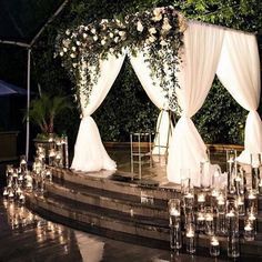 an outdoor wedding setup with candles and flowers