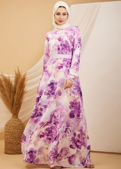 Step into refined elegance with our Lavender Blossom Elegance Crepe Maxi Dress. This captivating dress features a beautiful floral print in soft lavender and violet hues, perfect for adding a touch of grace to any occasion. Crafted from durable crepe polyester, the dress offers both comfort and style with a flowing skirt that moves effortlessly. The high neck and long sleeves provide a modest and sophisticated look, while the unlined design ensures a lightweight feel. Whether for a special event Lavender Blossom, Crepe Maxi Dress, Dress With Floral Print, Soft Lavender, Lavender Floral, Abaya Dress, Flowing Skirt, Modest Dresses, Floral Maxi Dress