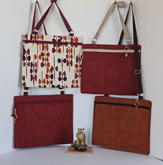 three purses are hanging on the wall