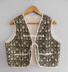 This is a Gorgeous Piece Of Cotton block printed quilted vest jacket. It is one of a kind jacket and a unique piece. This jacket is quilted with natural cotton filling inside with one side block print fabric and other side plain voile cotton inside. This is not reversible. Wear it with any black and white dress, or with jeans to add color and beauty. Handmade in India. The fabric is hand-dyed and stitched in layers using recycled cotton saris and then hand-stitched. Colored jacket, fashionable, Quilted Clothing Women, Vest Outfits For Women Vintage, Quilted Vest Jacket, Quilted Jacket Vest, Vests Over Dresses, Quilted Cotton Jacket, Quilted Sleeveless Jacket, Sewing A Vest, Printed Quilted Jacket