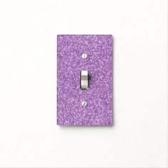 a single light switch cover in purple glitter