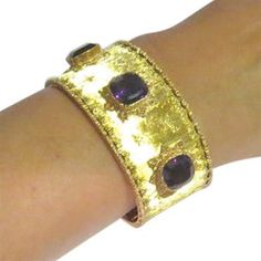 Beautiful 18k gold cuff with 3 10.5mm x 10.3mm amethyst gemstones DESIGNER: Buccellati MATERIAL: 18K Gold GEMSTONE: Amethyst DIMENSIONS: Bracelet will fit up to 6" wrist and is 28mm WEIGHT: 61.2g MARKED/TESTED: Buccellati,750 CONDITION: Estate PRODUCT ID: IN804 Luxury Yellow Gold Cuff Bracelet With Gemstone, Luxury Yellow Gold Amethyst Bracelets, Luxury Gold Amethyst Bracelets, Formal Yellow Gold Cuff Bracelet With Gemstone, Gold Amethyst Bracelets For Formal Occasions, Elegant Purple Gemstone Cuff Bracelet, Luxury Amethyst Bracelets For Formal Occasions, Gold Bracelet Cuff, Gold Cuffs