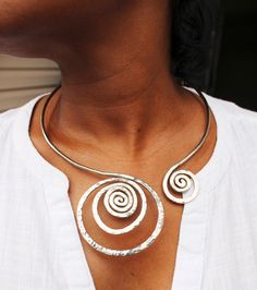 "This Open Collar Asymmetrical Necklace necklace is a Hand Hammered work of art. It will be the easiest necklace that you've ever put on in your life. Just slightly pull apart a few inches, slide it around your neck with a single hand and gently push it back to a comfy position. There are no clasps, no hooks, no connections. Be the envy, the talk of the town and stand out with this unique one of a kind body art. This is guaranteed comfort and be sure to get ready for lots of compliments. This is Artsy Silver Necklace With Unique Variations, Adjustable Silver Artsy Necklaces, Adjustable Silver Artsy Necklace, Artsy Adjustable Silver Necklace, Adjustable Artsy Silver Necklace, Artistic Hammered Silver Jewelry, Artsy Nickel-free Silver Necklace, Silver Artisan Choker Jewelry, Artisan Silver Choker Jewelry