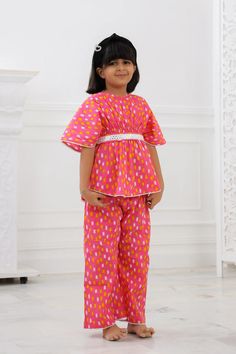 Our Girls Kurta Salwar is a must-have for your Girls. Made with 100% pure cotton cambric, this kurta is quite soft and tactile to touch making it a perfect match for your small one. Traditional print in pretty colours makes this kurta look distinctively good while wearing it. Composition: 100% cotton cambric The Kaftan Set is a gorgeous set of two pieces, includes a white cotton lace on Kaftan sleeves, Kaftan flare & pant bottom. The elasticated kaftan with a belt & loop for belt and elasticized pants to match, it has a button at the back that can be made secure or open, as you wish! Wash care : Hand wash separately in cold water. Use mild detergent. Dry in shade. Multicolor Short Sleeve Sets For Festivals, Cotton Short Sleeve Sets For Eid, Short Sleeve Cotton Sets For Eid, Festive Short Sleeve Cotton Kurta, Festive Cotton Kurta With Short Sleeves, Anarkali Cotton Set For Puja, Summer Cotton Sets With Bandhani Print, Pink Cotton Sets For Festive Occasions, Cotton Bandhani Print Sets For Summer