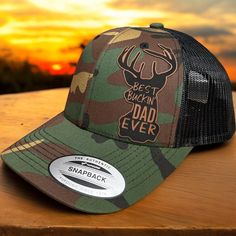 This is a custom made leather patch Hat!   These are made to order. Hat brand is Yupoong 6606 ! Trucker  style Hat with a SnapBack design. If you prefer another hat brand please message me as we do all types. Custom Deer Patch design that reads Best Buckin Dad Ever !  Hat pictured is camo and rawhide! Please choose your color of hat you would like and color of patch.  Leather Patches are bonded to all hats **not stitched on** We use a powerful leather bonding and heat pressed for maximum bonding to the hat .  We Do Custom Orders !  If you want a specific brand of hat or color feel free to message me I do all types of hats ! Outdoor Trucker Hat For Father's Day, Father's Day Trucker Hat For Outdoor, Father's Day Outdoor Trucker Hat, Father's Day Outdoor Trucker Hat With Curved Bill, Father's Day Baseball Cap With Curved Brim, Customizable Trucker Hat With Flat Brim For Outdoor, Custom Outdoor Hat With Flat Bill, Brown Trucker Hat For Father's Day, Customizable Flat Brim Trucker Hat For Outdoor