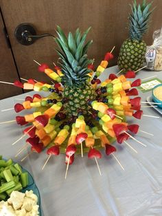 a table topped with fruit and veggies on skewers