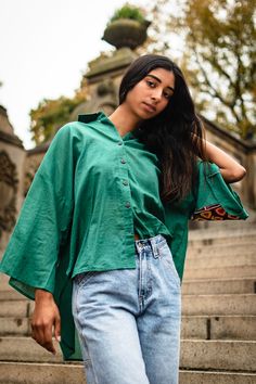 Oversized high-low shirt with dropped shoulders in teal green with wooden buttons and subtle bell sleeves. Elbow patch embellished with preloved Kutchi hand embroidery by the artisan of Kutch, Gujarat. Note: Embroidery patch (color and design) vary in each piece Handcrafted in India Oversized Green Shirt For Fall, Embroidered Green Blouse For Fall, Oversized Embroidered Cotton Blouse, Green Traditional Top For Fall, Traditional Green Tops For Fall, Traditional Green Top For Fall, Green Embroidered Relaxed Fit Blouse, Green Embroidered Blouse With Relaxed Fit, Traditional Green Shirt For Spring