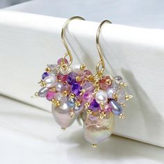 Baroque Pearl Earrings, Pink Tourmaline Amethyst Cluster Earring, Gold Fill Earrings, Rainbow Metallic Earrings, Romantic Wedding Earrings Beautiful, rainbow metallic hued baroque pearls, mounted on 14 kt yellow gold filled wires, dangle beneath clusters of gemstones and pearls in pinks, gold, lavender, purple and gray hues reflecting the colors in the pearls' nacre to create these romantic pearl earrings. Gems of pink tourmaline, purple and pink amethyst and pink tourmaline and more cluster wit Amethyst Gemstone Wedding Earrings, Amethyst Gemstone Earrings For Wedding, Handmade Amethyst Wedding Earrings, Amethyst Earrings With Gemstone Accents For Wedding, Handmade Amethyst Earrings For Wedding, Wedding Earrings With Amethyst And Gemstone Accents, Wedding Amethyst Earrings With Gemstone Accents, Purple Briolette Earrings For Wedding, Briolette Gemstone Earrings For Wedding