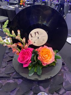 there is a record and flowers on the table