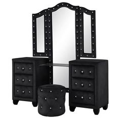 a black vanity with mirror and stool next to it