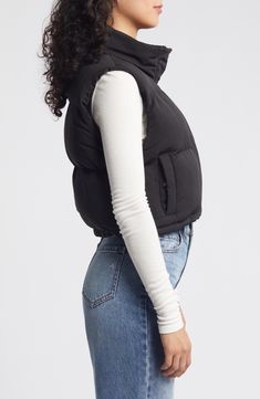 Add a light layer to your cool-weather look with a zip-up puffer vest that's channel-quilted and cropped for a contemporary silhouette. 18" length (size medium) Front zip closure with snap storm placket Stand collar Front snap-welt pockets Lined, with polyester fill 100% polyester Hand wash, dry flat Imported Black Puffer Gilet Outfit, Cropped Black Vest Outfit, Urban Nylon Puffer Jacket For Spring, Spring Nylon Puffer Vest, Fitted Winter Vest With Zipper Closure, Fitted Puffer Vest For Cold Weather, Versatile Fitted Winter Vest, Trendy Nylon Spring Vest, Black Vest With Padded Collar For Fall