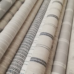 several different types of fabric are lined up together in rows and stacked on top of each other