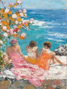 three women sitting on the beach looking out at the ocean with flowers in their hair