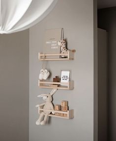 three wooden shelves with stuffed animals on them in a nursery or kids's room