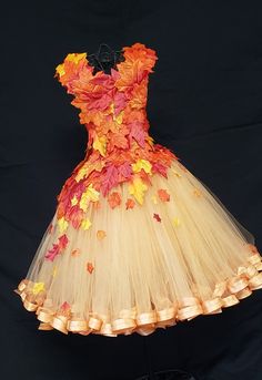 a dress made out of tulle with leaves on it