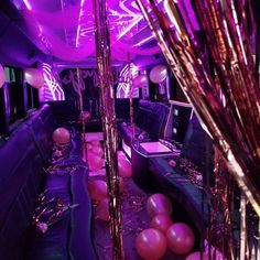 a party bus with balloons and streamers on the floor, couches and tables