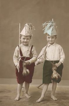 two young boys wearing hats and holding carrots in front of an old - fashioned photo