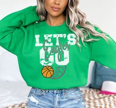 This custom basketball sweatshirt is soft and comfortable, perfect to keep you warm and cozy on basketball game day. Make this sweatshirt extra special by personalizing it with your favorite team name. HOW TO ORDER: Please leave the team or mascot name in the "Add your personalization" text box. Please message me if you have any questions before ordering. This UNISEX FIT sweatshirt will last for years. Good quality material that needs no ironing. Do not iron directly on design.  Please see image Green Fan Apparel Sweatshirt For Sports Events, Basketball Cotton Sweatshirt For Sports Season, Cotton Sweatshirt For Basketball Sports Season, Long Sleeve Basketball Sweatshirt For Sports Season, Long Sleeve Basketball Sweatshirt, Sporty Long Sleeve Basketball Top, Basketball Mom Shirts, Basketball Sweatshirts, Basketball Tees