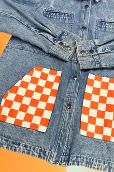 This unique Smiley Vols Checkered Pocket Hand Painted Long Cargo Denim Jacket features a playful smiley design, practical cargo pockets, and charming hand-painted details. Made with durable denim, it is perfect for adding a touch of fun to your wardrobe while providing functional storage. Details:- Hand-painted at JFY- One of a Kind- Cargo Style Denim Jacket- Perfect Game Day Gear Fabric Content:- 100% Cotton Washing Instructions:Turn fabric inside out on first wash. Wash gentle with warm water. Trendy Cotton Denim Jacket With Pockets, Trendy Denim Jacket With Patch Pockets, Trendy Recycled Denim Outerwear With Pockets, Trendy Denim Jacket With Multiple Pockets, Retro Spring Denim Jacket With Patch Pockets, Spring Cotton Denim Jacket With Cargo Pockets, Cotton Denim Jacket With Cargo Pockets For Spring, Trendy Denim Blue Jacket With Patch Pockets, Spring Cotton Denim Jacket With Side Pockets