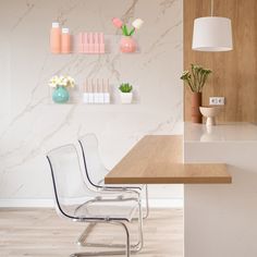 a white chair sitting on top of a wooden counter next to a wall mounted shelf