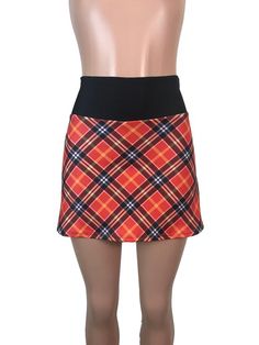 Step up your game in this fun and colorful athletic skirt with built in compression shorts and pocket.  This golf, tennis, running or sports skirt is slim-style, but allows for plenty of movement, made of a red plaid high quality performance spandex. The compression shorts are uniquely designed to be incredibly comfortable and won't ride up during activity. The pocket is positioned on the side of the shorts, and will fit your phone, keys, ID, etc. *Please see size chart in images above for stand Stretch Mini Skirt With Built-in Shorts For Tennis, Tennis Mini Skirt With Built-in Shorts And Stretch, Stretch Mini Skirt For Tennis, Fitted Tennis Skort With Lined Skirt, Stretch Lined Mini Skirt For Tennis, Casual Fitted Swim Skirt For Sports, Fitted Mini Skort For Tennis, Fitted Tennis Skort, Fitted Lined Swim Skirt For Sports