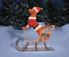 a lighted reindeer sleigh in the snow