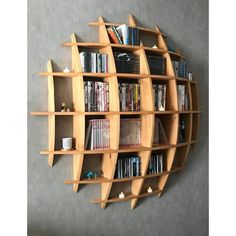 a bookshelf with several shelves filled with books and dvds on the top shelf