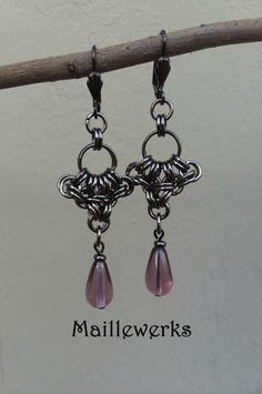 These Long and Dramatic Chainmaille Earrings are handcrafted with Amethyst Purple Glass Teardrops and more than 60 antiqued black gunmetal plated metal jump rings.  Gunmetal Lever Back Ear Wires for pierced ears.   Earring Length from top of Ear Wires to bottom 2 3/4" (7 cm) long and 3/4" (2 cm) wide. Wonderful gift for that special February born person in your life! Necklace sold separately. See matching Necklace here!: https://www.etsy.com/Maillewerks/listing/1454765426 Chainmaille has a fluid February Born, Gunmetal Jewelry, Chainmaille Earrings, Chainmaille Jewelry, Chainmail Jewelry, February Birthday, Chain Maille Jewelry, Anniversary Jewelry, Amethyst Purple