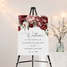 an easel with a sign that says welcome to the wedding of elizabeth wilson and jeffy russell