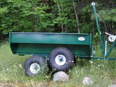 a green dump truck sitting in the grass