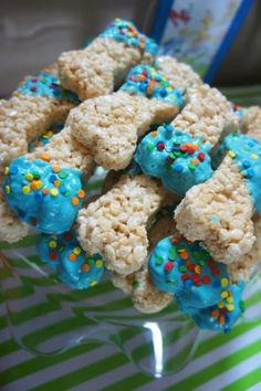 rice krispy treats with blue frosting and sprinkles on a plate