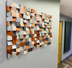 a wall sculpture made out of wooden blocks