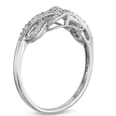 a white gold ring with diamonds on the sides and an oval shaped design in the middle