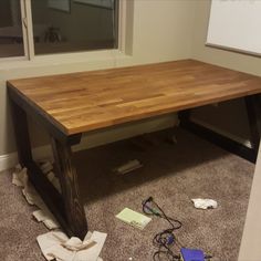 a wooden table sitting on top of a carpeted floor