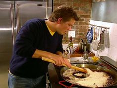 a man cooking food in a pan on the stove