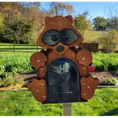 a mailbox with an owl face on it's front and the letter m in the middle